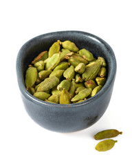 cardamom pods in a black bowl