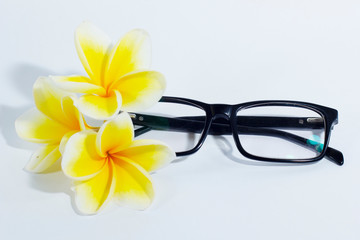 conceptual eyeglass with frangipani flowers on the glass