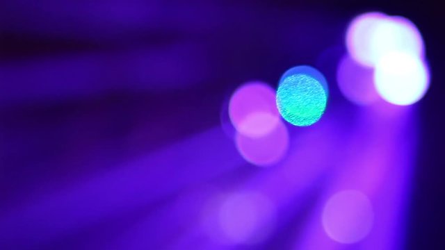 Beautiful flickering in darkness disco lights at nightclub background. Changing bright blue, green, purple, red colors with flares. Real time full hd video footage