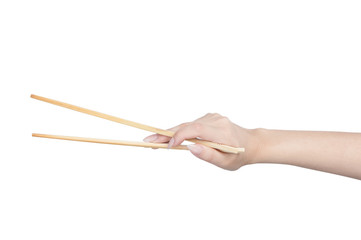 Female hand holding wooden chopsticks