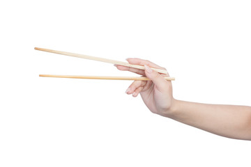 Female hand holding wooden chopsticks