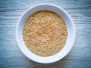 Golden linseed in white bowl