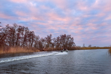 Boat rushing on a wild river in the early morning.