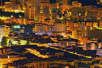 Principality Monaco at night. Scenic landscape view of luxury multi-story residential buildings near the port. Famous touristic place and travel destination in Europe