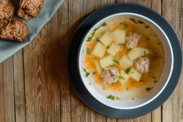 Vegetable soup with chicken cutlets and pieaces of homemade bread.Top view with copy space.