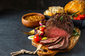Fresh grilled meat. Grilled beef steak medium rare on wooden cutting board.