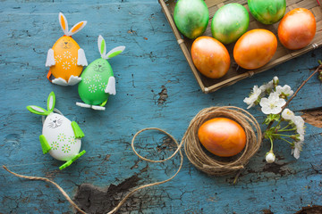 Easter Eggs and bunny background. Beautiful colorful eggs on blue table,