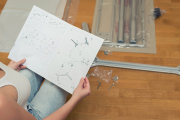 Instruction for furniture assembling in the female hands for self assembly.