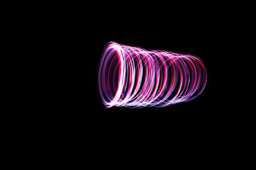 Light painting of continuous red and white spirals forming a tube figure. Dynamic time trajectory of two lights simultaneously. © Maarten Zeehandelaar