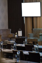 Two armchairs be speaker table in luxury conference room before seminar.