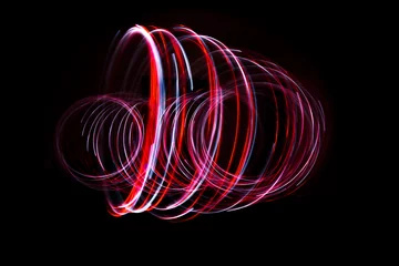 Fotobehang Light painting of red and continuous white spirals forming a 3D shape. Dynamic time trajectory of two lights simultaneously. © Maarten Zeehandelaar
