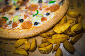A whole big pizza close-up on a gray background. Colorful pizza topping closeup
