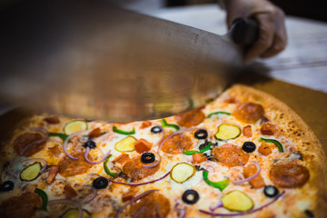 Appetizing large pizza cut into pieces, lying on the Board with numbers indicating its diameter...