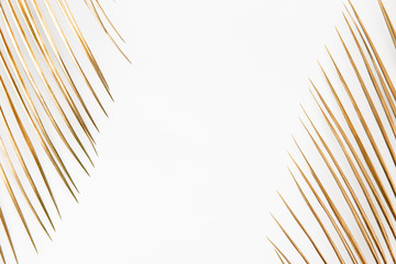 Fototapeta premium Golden palm leaves on white background