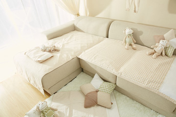 There are sofa and pillow in children's room.