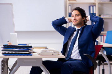 Young handsome businessman working in the office