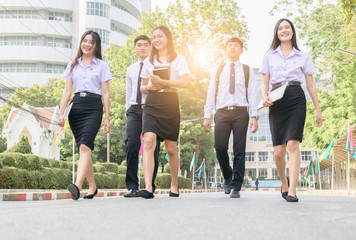 Obraz premium Happy and smart student walking on road