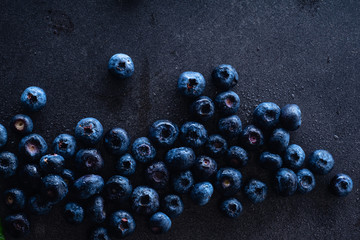 Fresh ripe blueberries on dark background with copy space