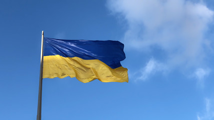 national symbol of ukrainian people - blue and yellow banner is fluttering in the wind.