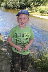 Happy little boy by the river