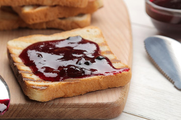 toasts with jam. fried crispy toasts with red jam on a white wooden table. breakfast. close-up