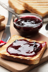 toasts with jam. fried crispy toasts with red jam on a white wooden table. breakfast. close-up