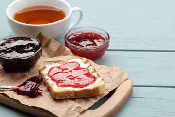 toasts with jam. fried crispy toast with red jam on a blue wooden table. breakfast.