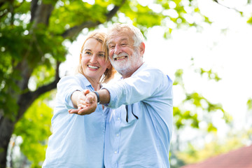 Portrait Happy Elderly couple dancei with happiness in the garden