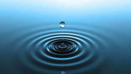 Drop of water falling into water