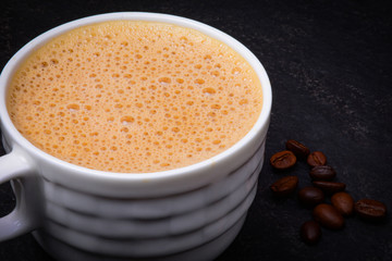 Cup of hot coffee on black background