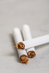 Macro View of the cigarettes and tobacco stack. The tobacco plant is part of the genus nicotiana and of the solanaceae (nightshade) family. Close up with copy paste space, in the gray background