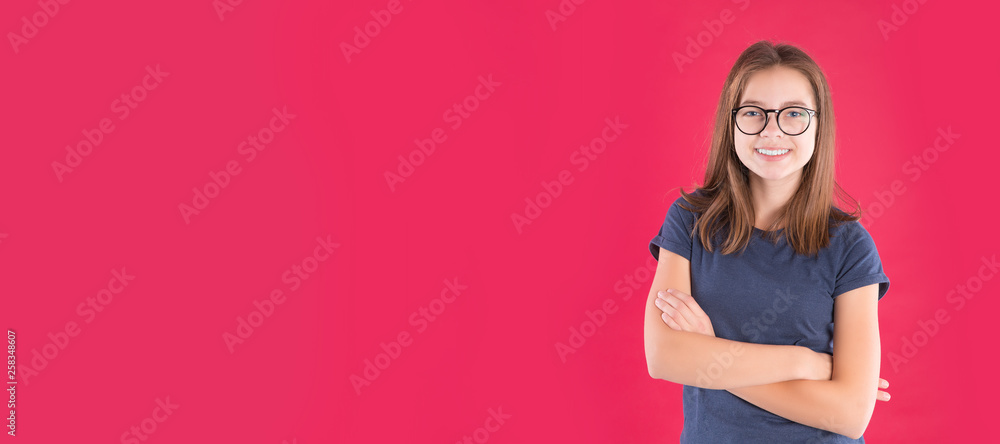 Wall mural Portrait of happy funny teen girl over red background