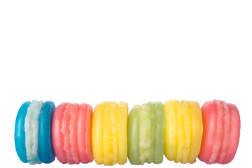 macaroons cake in soft colors on the pastel green glass background