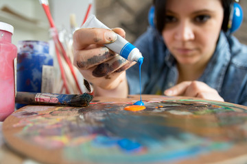 Beautiful female artist with acrylic paint