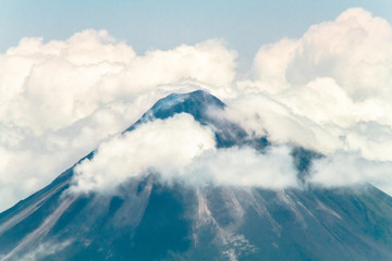 The summit of Volcan Arenal among the clouds in central Costa Rica.