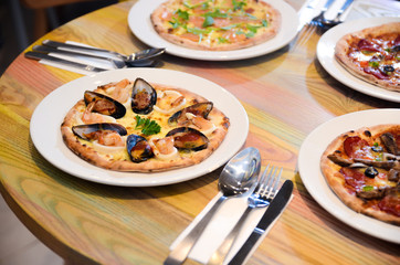 Slice of hot pizza cheese lunch or dinner crust seafood meat topping sauce with bell pepper vegetables delicious tasty fast food italian traditional on wooden board table classic with delivery hand 