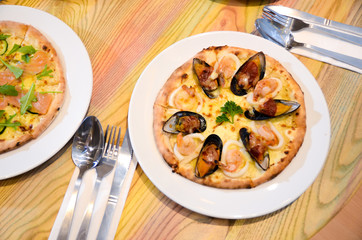 Slice of hot pizza cheese lunch or dinner crust seafood meat topping sauce with bell pepper vegetables delicious tasty fast food italian traditional on wooden board table classic with delivery hand 