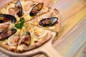 Slice of hot pizza cheese lunch or dinner crust seafood meat topping sauce with bell pepper vegetables delicious tasty fast food italian traditional on wooden board table classic with delivery hand 