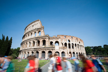 Fototapeta na wymiar Tourists walking past the Colosseum during the day rome italy