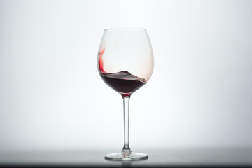 Wine glass with red wine on white background