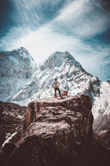 Triumphant hiker in front of ama dablam mountain