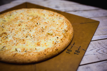 A slice of pizza close-up, appetizing pizza filling, cheese. Hand takes a separate piece of pizza