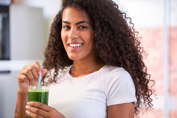 Young african woman enjoy healthy vegetarian smoothie for weight loss and detox 