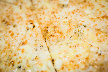 A slice of pizza close-up, appetizing pizza filling, cheese. Hand takes a separate piece of pizza