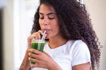 Young african woman enjoy healthy vegetarian smoothie for weight loss and detox - Imagem
