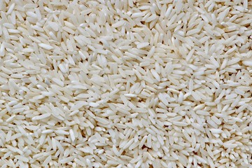 Close up background image of raw long grain rice filling the entire frame.