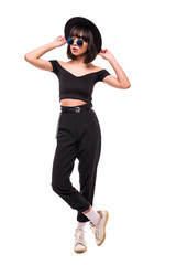 Full-length portrait young elegant woman in black hat. Fashion studio shot