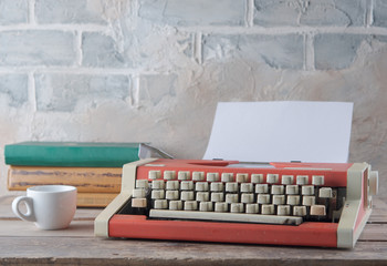 Red typewriter on the table and coffee