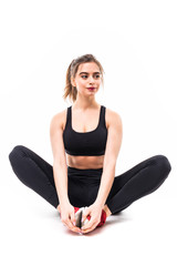 Fototapeta premium Portrait of a smiling fitness woman resting while sitting and looking at camera isolated over white background