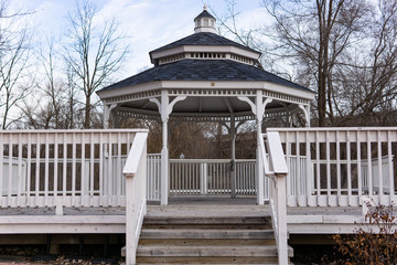 White gazebo with steps and fence